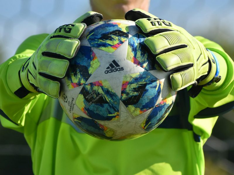 Goalkeeper holding the ball securely in both gloves